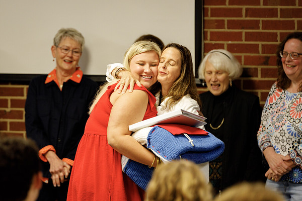 senior receiving a blanket from CAMP