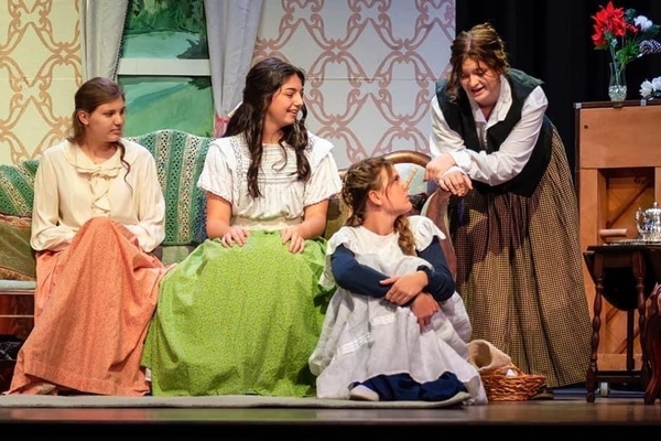 Students on stage acting in a play