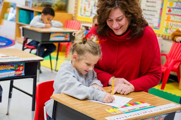 Teacher helping student