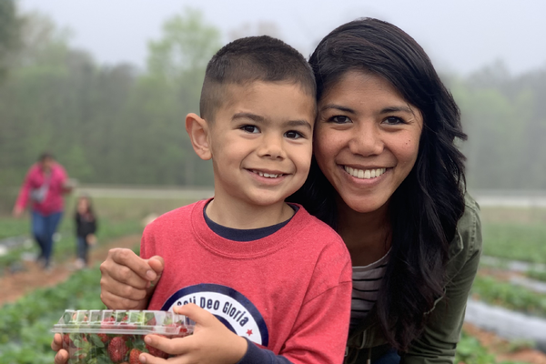 student and parent in the strawberry patch