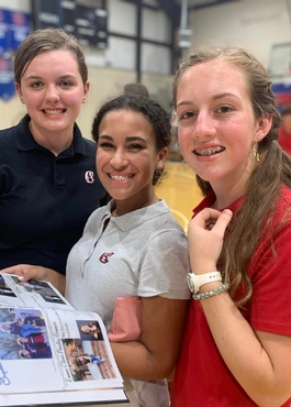 Logic School Girls holding yearbook