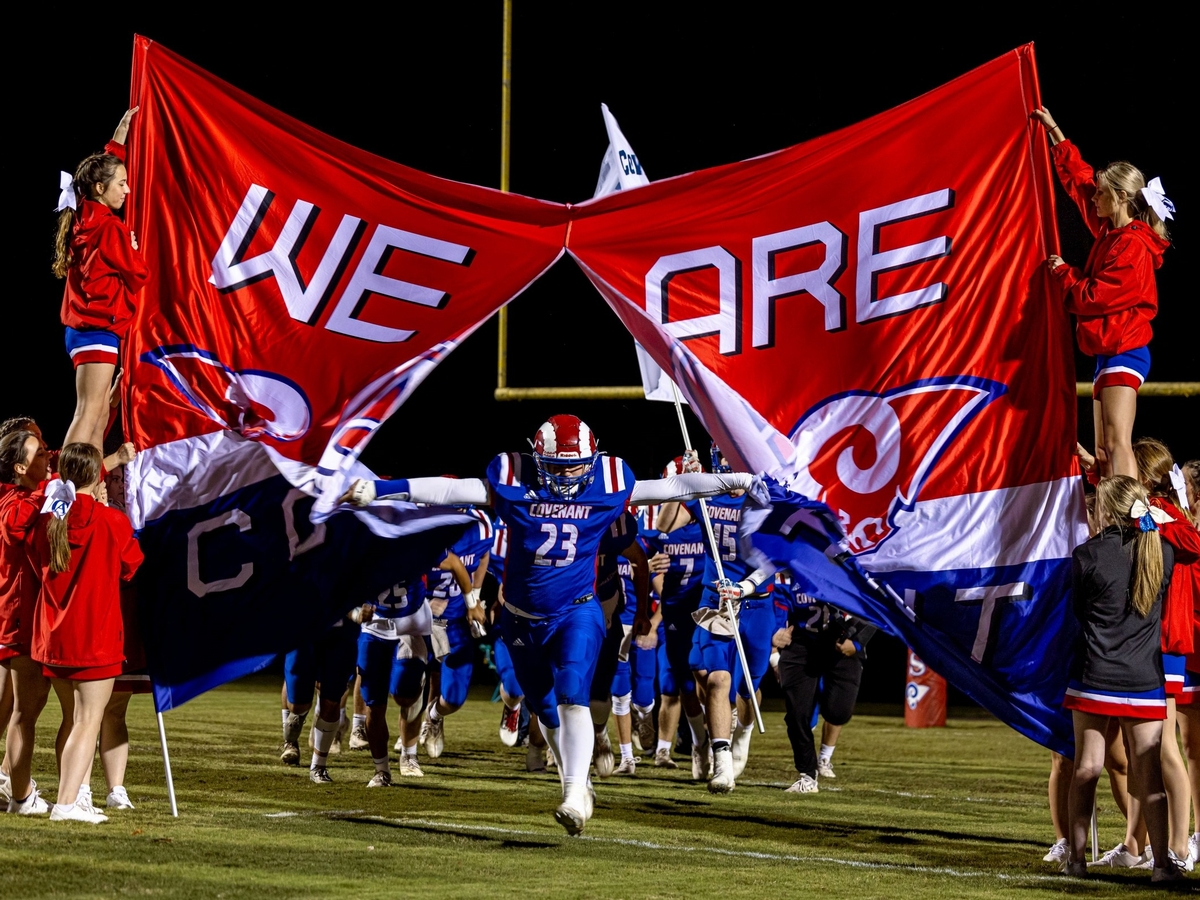 Football players running onto field