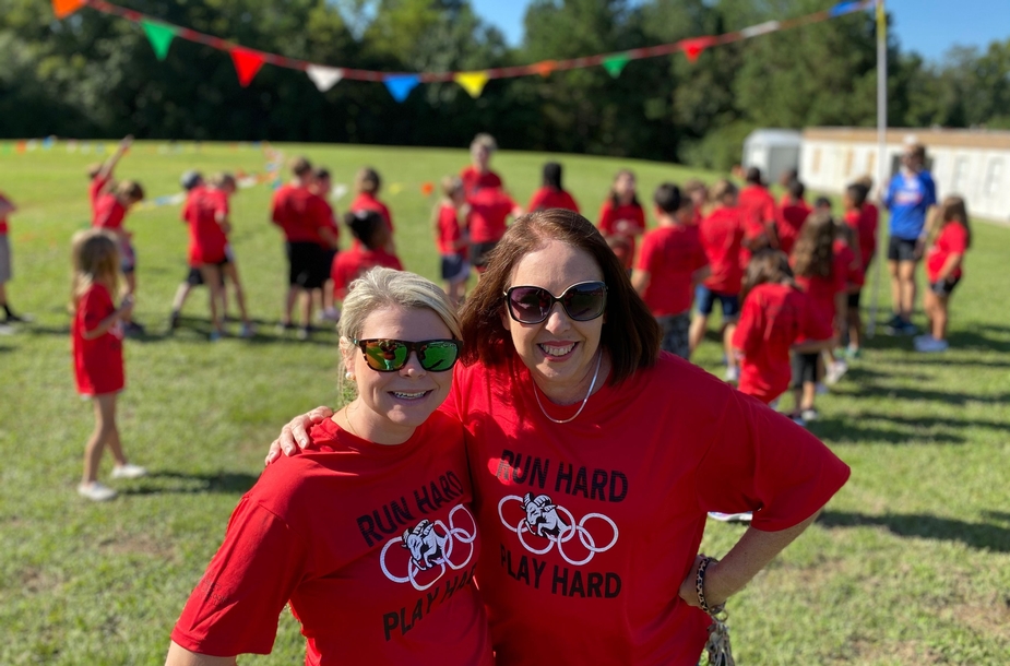 Teachers smiling in sunglasses with students